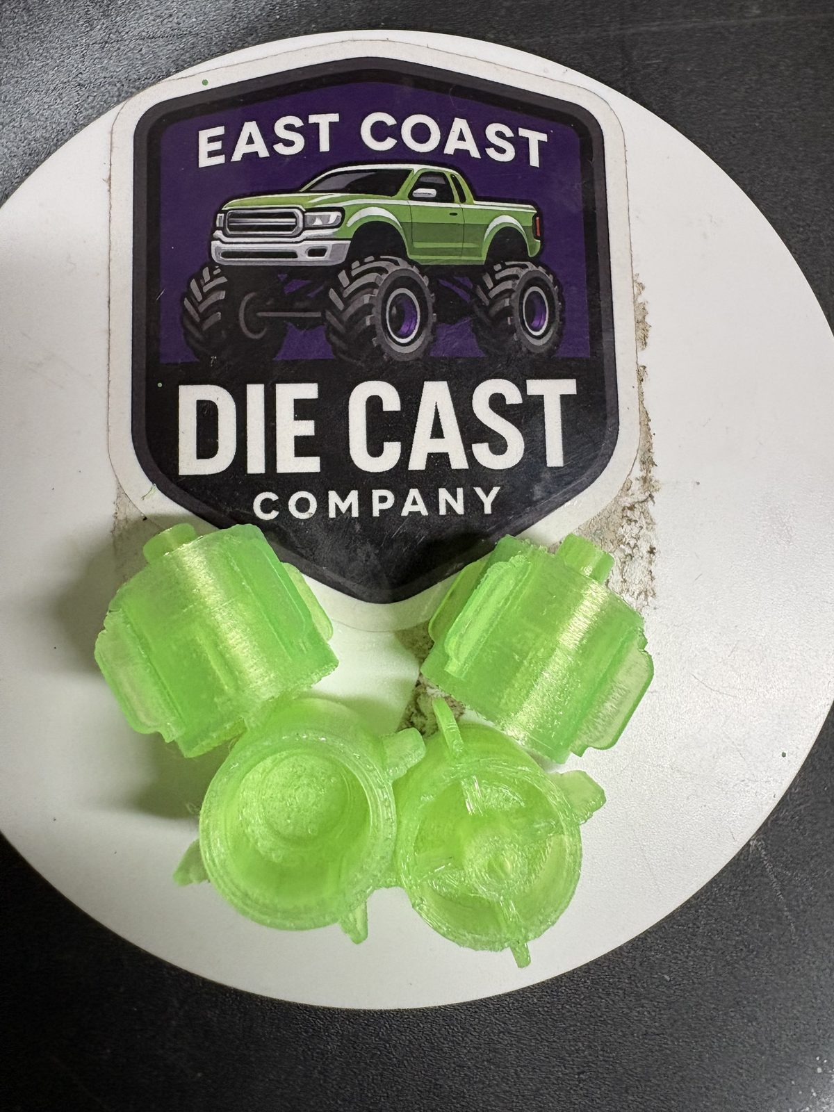 Green 3D-printed wheel hubs and chassis parts